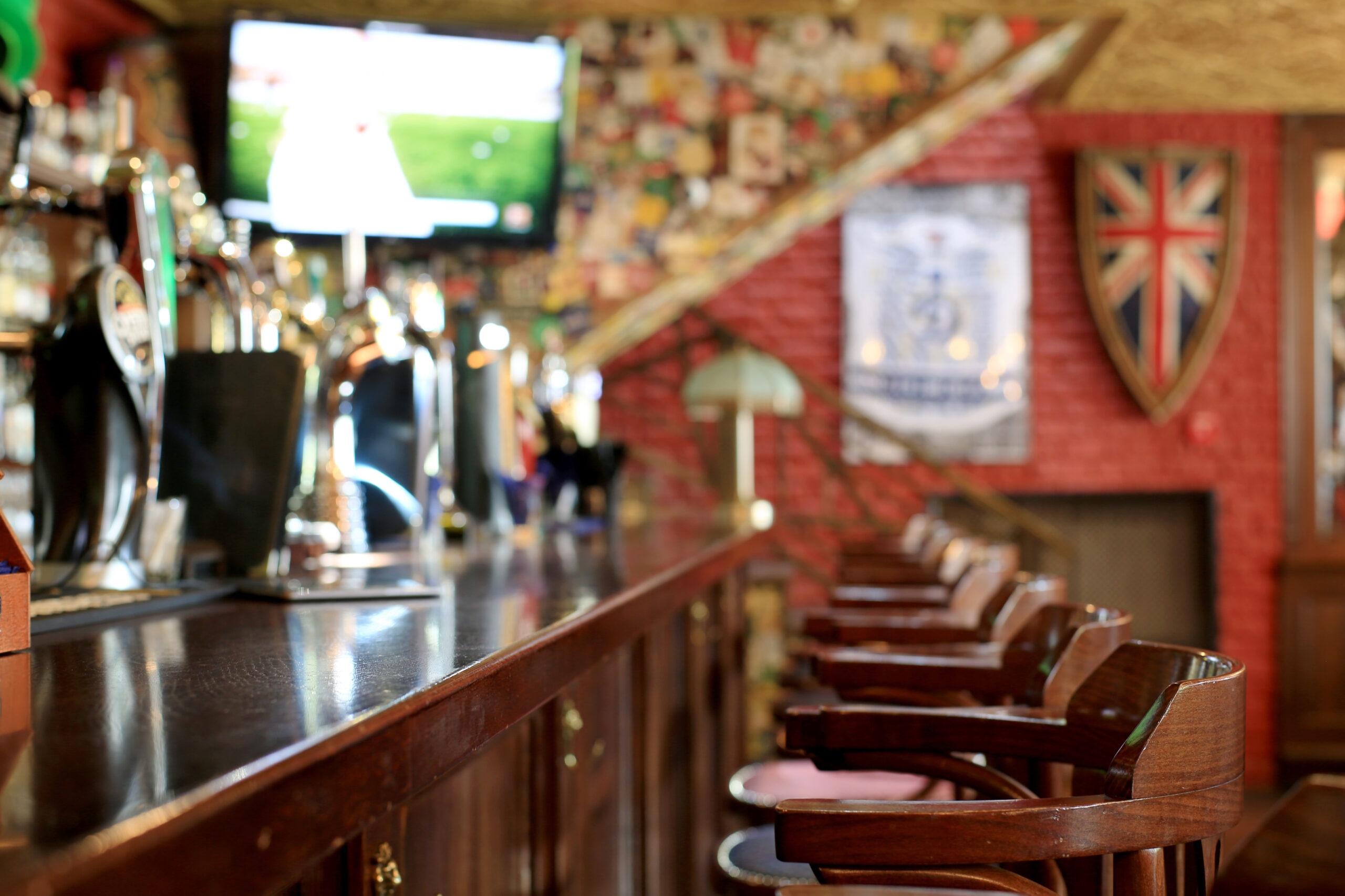 View of bar and football on a TV screen in pub