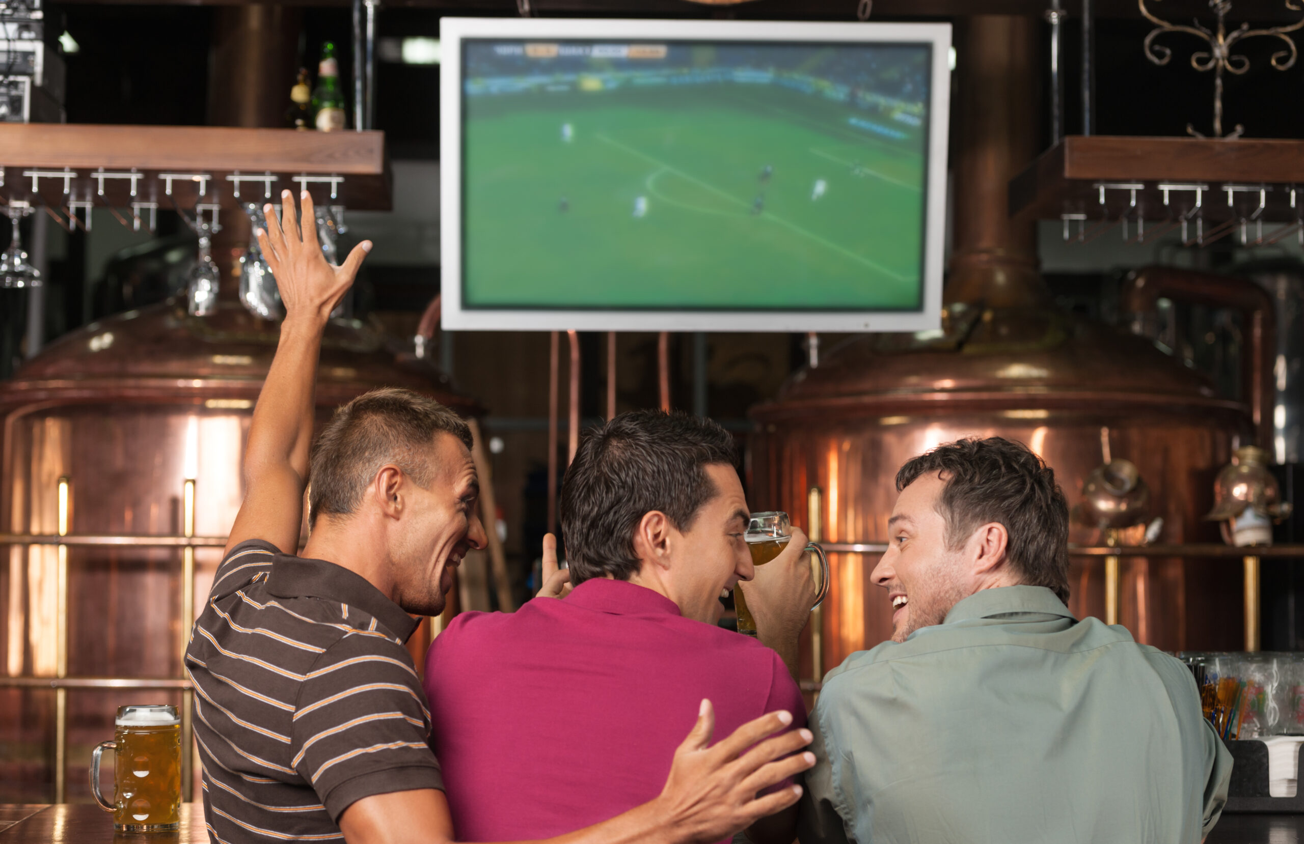 Men watching football on the TV in pub